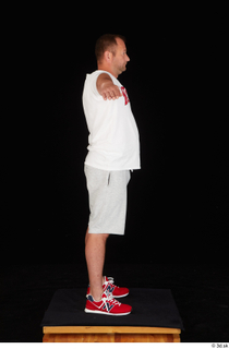 Louis dressed grey shorts red sneakers sports standing t poses…